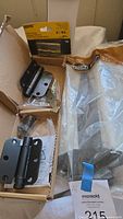 overview showing black self-closing hinge set, Stanley utility hinges pack, Everbilt tee hinges bag