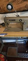 Brother industrial sewing machine on metal table with lamp and foot pedal
