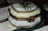 Closed trinket box showing exterior decoration and gilt hinge