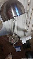 Chrome adjustable desk lamp and white clamp-on light on table