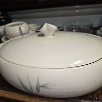 Large lidded serving dish showing bamboo pattern and glaze