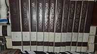 Row of World Book Encyclopedia volumes A–L showing spine design and wear
