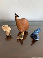 All four bird figurines together