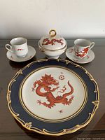 Full set: 2 teacups, 2 saucers, plate, lidded container with dragon design