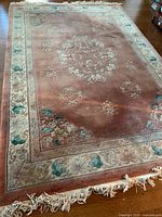 Full view of rug showing overall design, borders and fringe