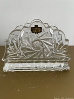 Front view of cut crystal napkin holder with gold foil label visible