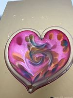 Top view of heart-shaped art glass dish showing swirl colours and clear rim