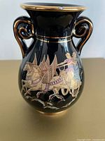 Front view showing chariot scene, handles, gold trim