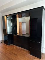 Front angled view showing entire high-gloss headboard system with side towers