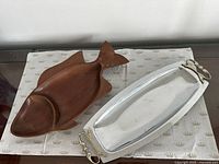 Metal tray and wooden fish tray together, top view