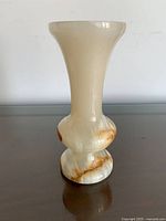 Front view of cream and caramel banded onyx vase