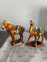 Front view of horse and camel figurines