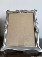 Front view of pewter picture frame with floral relief