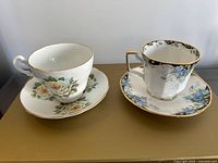 Both teacup and saucer sets side by side showing patterns and shapes