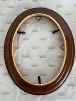 Front view of oval wood frame with gold gilt edge