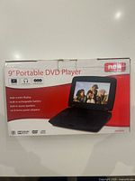 Front of retail box showing brand, features and image of the 9-inch portable DVD player