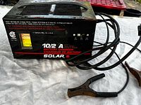 Front and top view of Solar MT210C charger with attached clamps