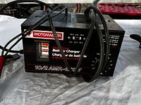 Front and top view of the Motomaster 10/2A battery charger with cables