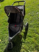 Front view of BOB jogging stroller on grass