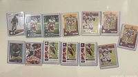 All fourteen Chase Young NFL trading cards in protectors