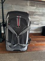 Front view showing logo, backpack straps, red stripe