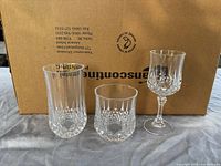 Three representative glasses in front of shipping box: highball, lowball and stemmed goblet