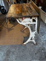 Full side view showing cast-iron base, wooden desktop