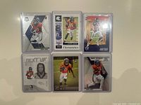 Six Jerry Jeudy rookie NFL trading cards in sleeves displayed on flat surface