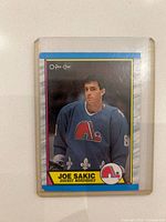 Front of Joe Sakic rookie card in sleeve