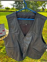 Front view showing snap closure, pockets, overall condition