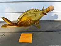 Right view of amber glass fish decanter with cork stopper