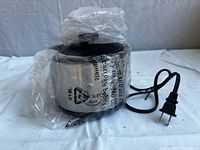 Crock-Pot Little Dipper warmer wrapped in original plastic with power cord visible