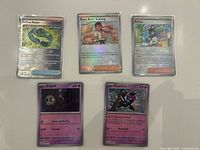 Front of five sleeved Pokémon cards showing names and artwork