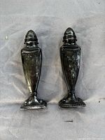 Front view of both sterling silver shakers