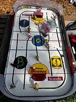 Overview of Stiga tabletop ice hockey game showing rink, players and bag of extra figures
