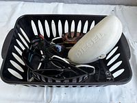 Overview of basket containing assorted sunglasses and DIFF case