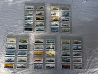 Four binder pages holding 40 Naval Craft cigarette cards displayed on cloth background