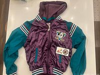 Front view of Mighty Ducks bomber showing hood, pockets, chest logo