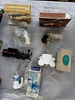 overview of boxed and loose Avon decanters including pistols, train, coach, pipe