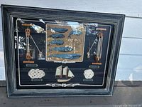 Front view of framed shadowbox showing all elements