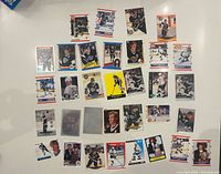 Overall shot of about 30 Wayne Gretzky hockey cards laid out on white surface