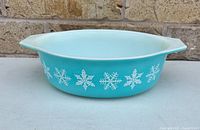 Side view showing turquoise body, white snowflake pattern and handle