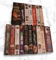 Group shot of all 17 sealed VHS tapes showing titles and sealed packaging