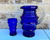 Pitcher and tumbler side by side showing size comparison and cobalt color