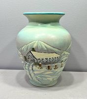 Front view showing covered bridge winter scene and vase shape