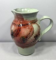 Front view showing handle, spout and glaze pattern