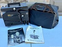 Projector, reel, bag and manuals overview