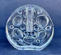 Front view of clear round art glass vase showing bubble relief pattern and central neck