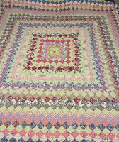 Full view of quilt laid flat showing overall pattern and colours