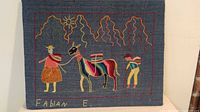 Full view of Andean yarn painting showing entire scene, signature and mounting